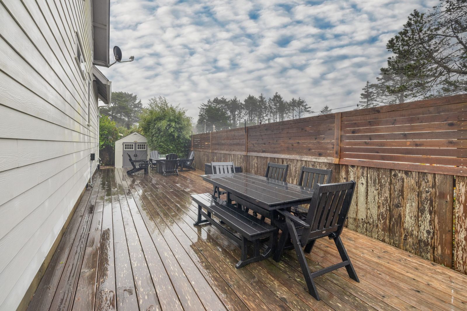 Outdoor dining table on the fenced back deck