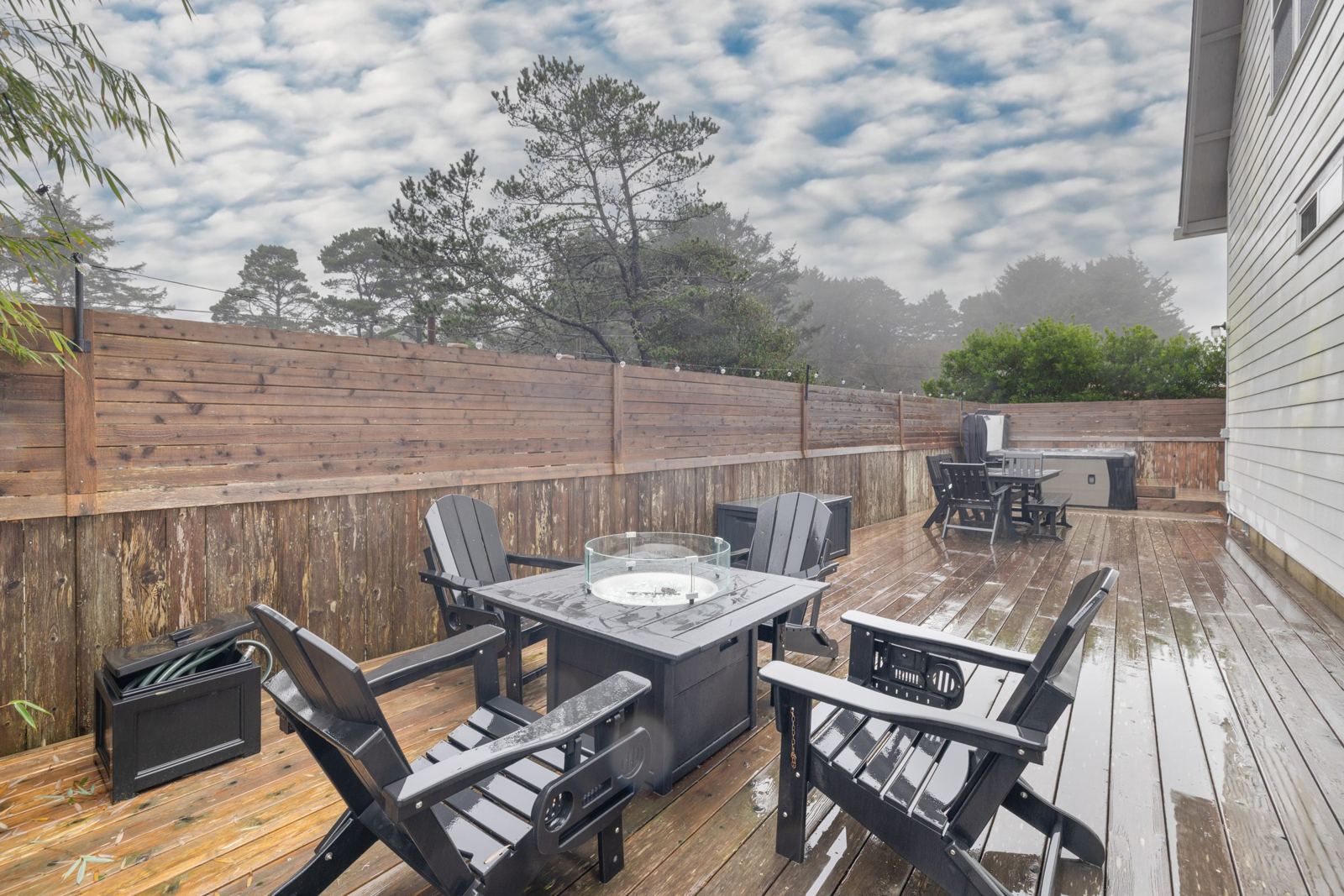 Propane fire pit and Adirondack chairs on the deck